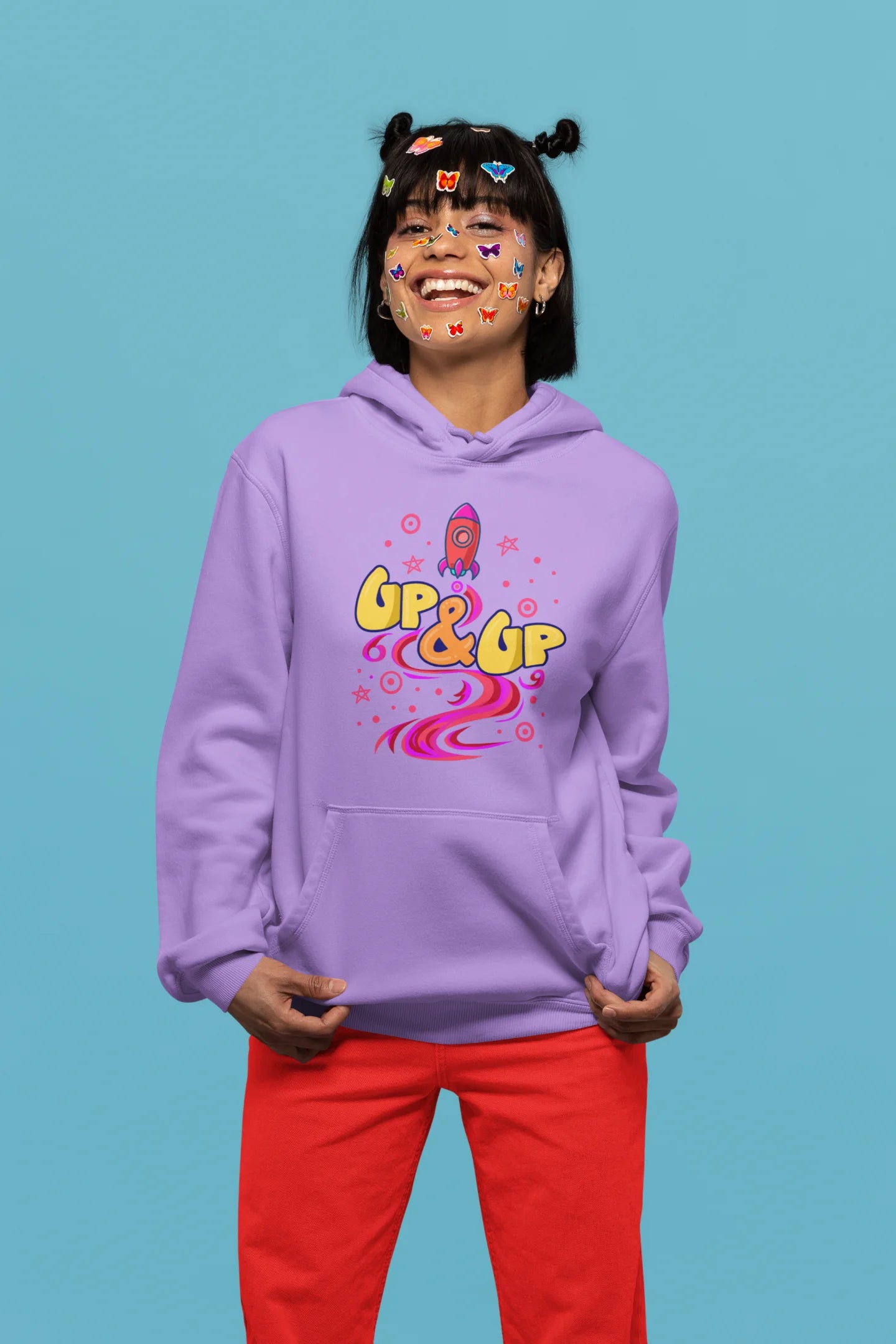 First front view of a female model wearing an lavender hoodie with a rocket ship design and the text "Up & Up".