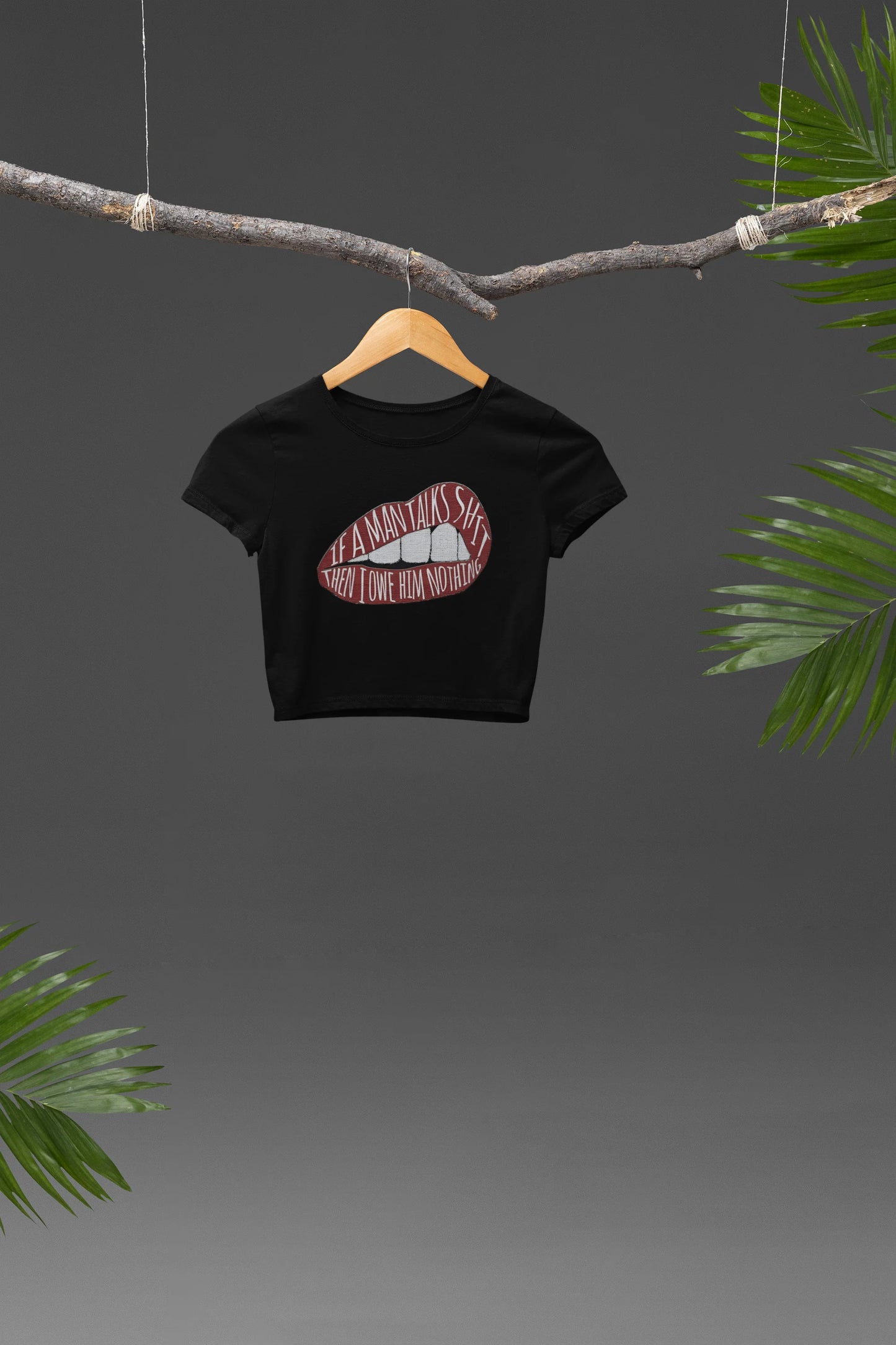 Front view of a black crop top featuring the empowering message "You Owe Him Nothing," inspired by Taylor Swift's lyrics. This piece is a must-have for Swifties who value self-respect and independence.