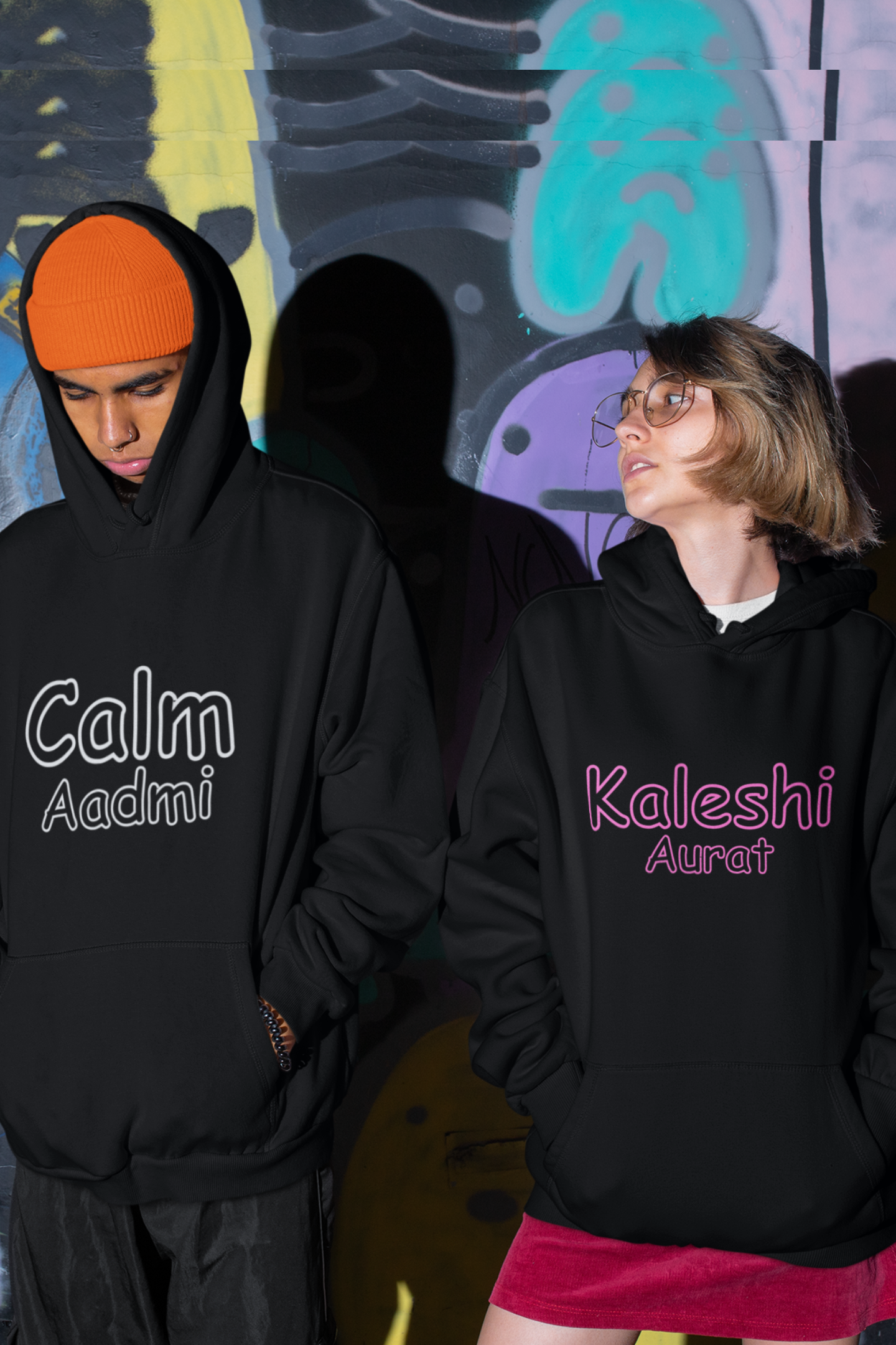 A couple wearing matching hoodies, one with "Calm one" and the other with "Chaotic one" printed on them in Hindi.