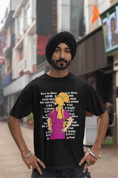 Fourth image of a male model wearing a black oversized t-shirt with a Diljit Dosanjh portrait on a t-shirt with his album titles written in the background.