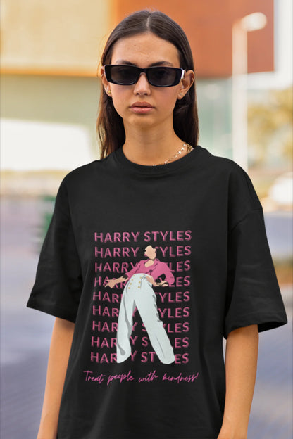 First image of female model wearing black oversized t-shirt inspired by Harry Styles, featuring the 'Treat People with Kindness' mantra from the Fine Line collection.