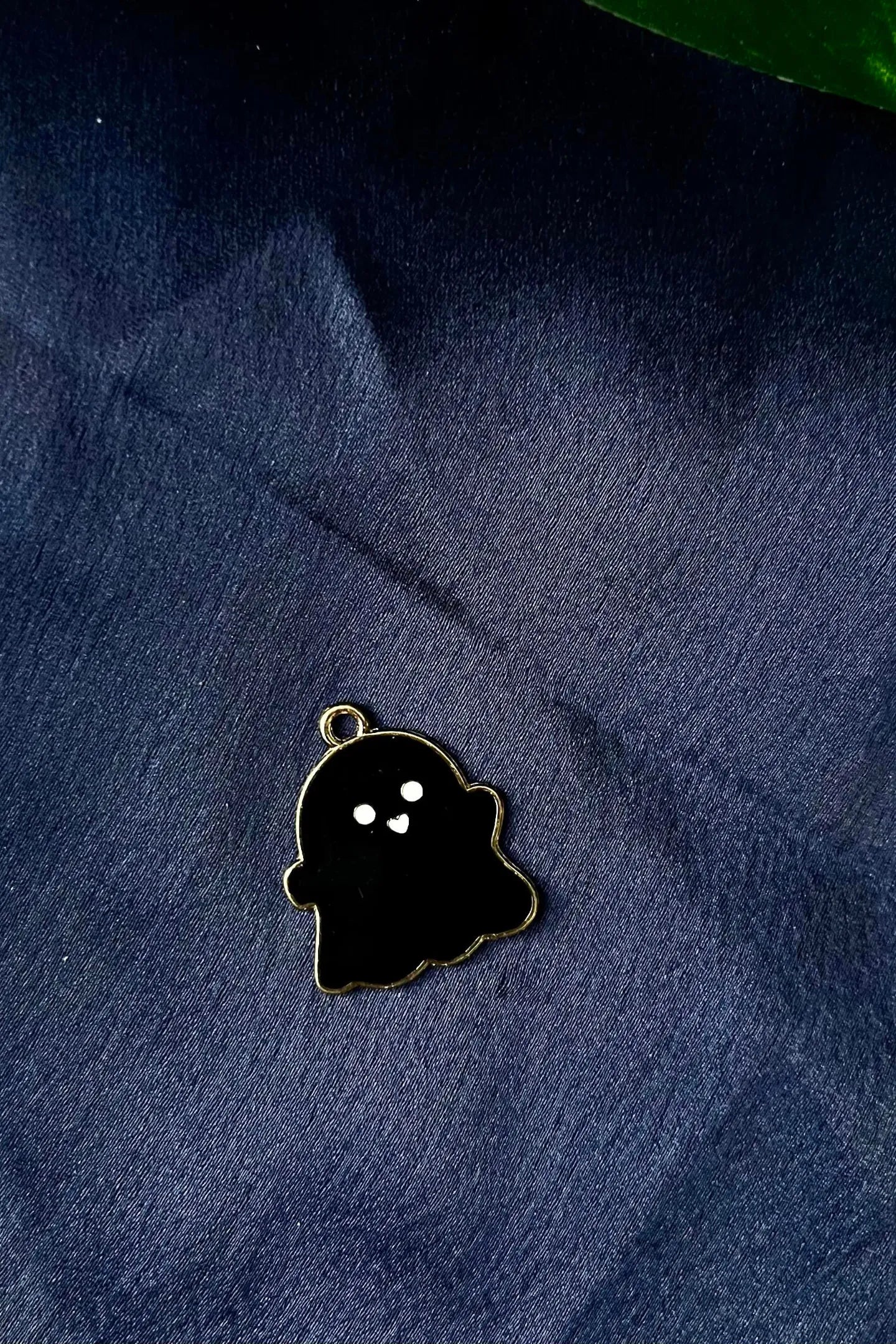 Second view of a charm featuring a cute black spooky adorable ghost design.
