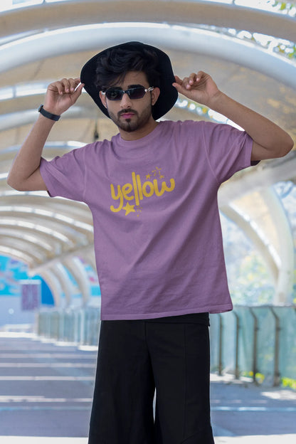 Third front view of a male model wearing a dirty purple oversized t-shirt with the "Yellow" album artwork by Coldplay.