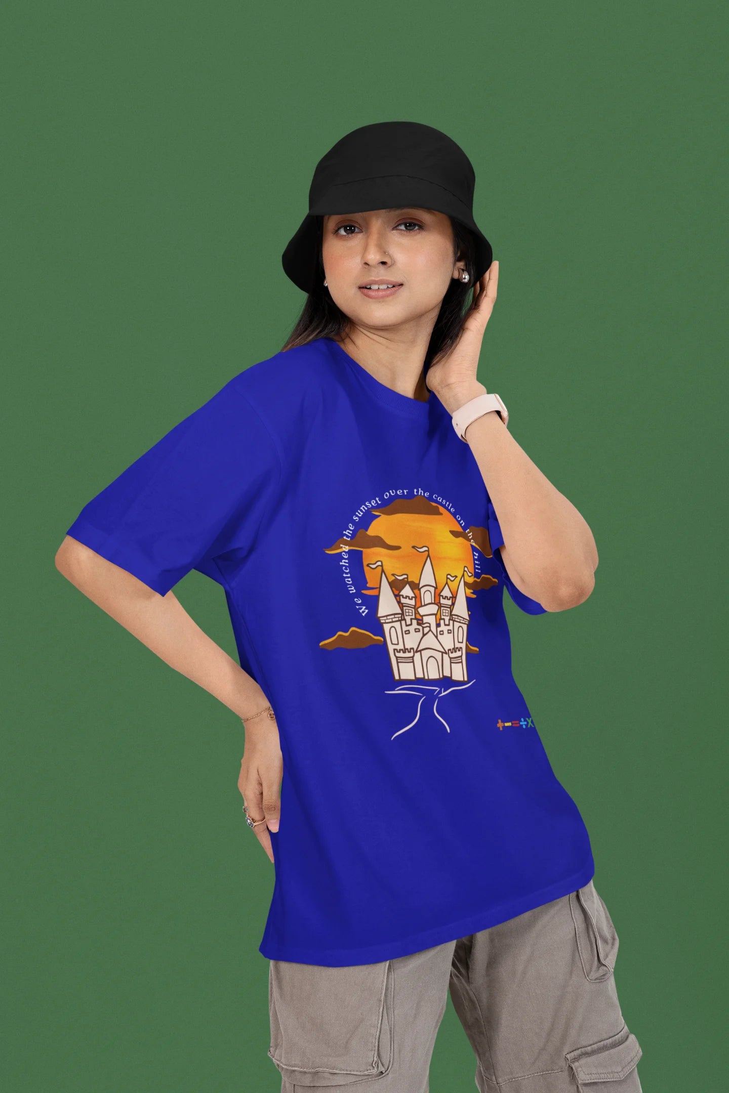 3rd front view of a female model wearing a royal blue oversized t-shirt featuring a nostalgic sunset and castle design, related to Ed Sheeran's "Castle on the Hill."