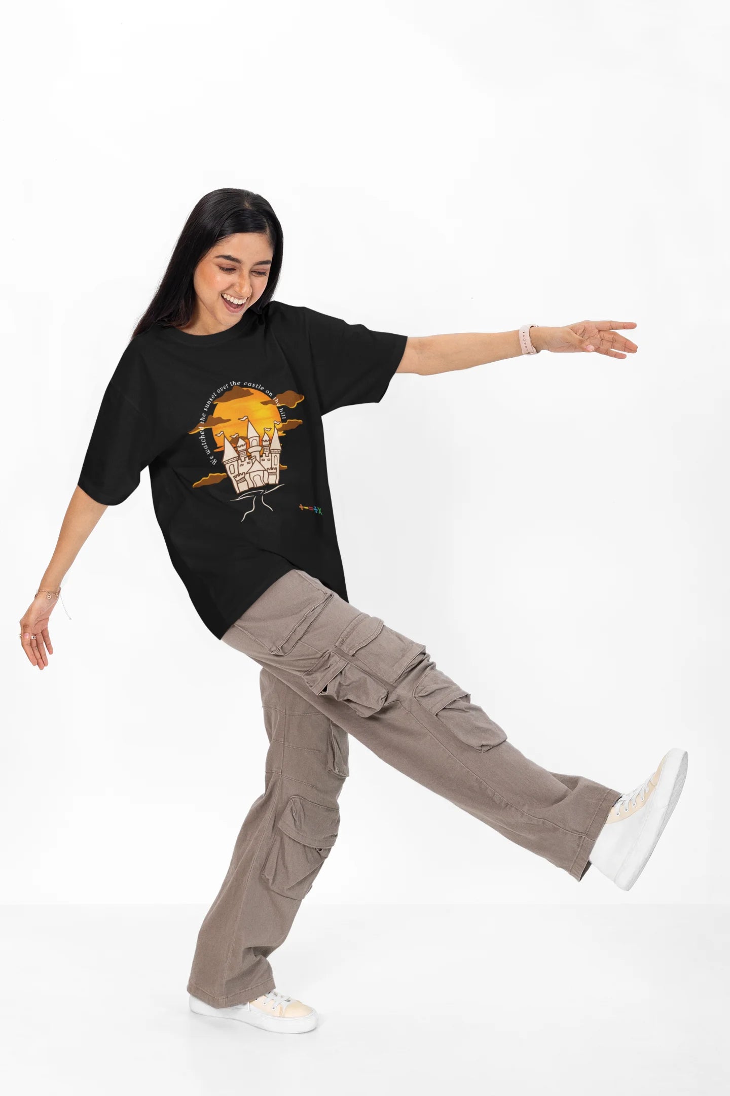 4th front view of a female model wearing a black oversized t-shirt featuring a nostalgic sunset and castle design, related to Ed Sheeran's "Castle on the Hill."