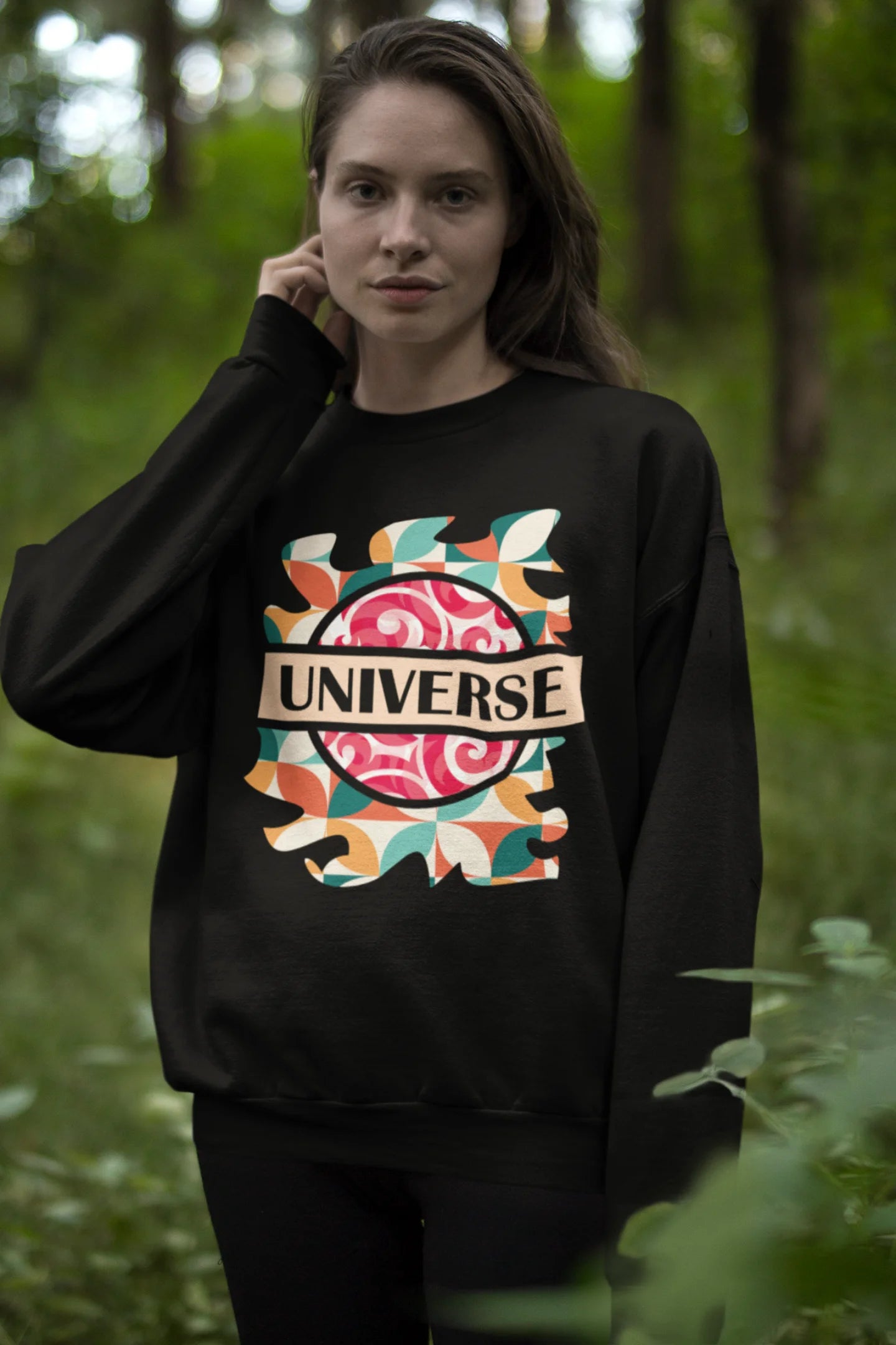 Second front view of a female model wearing an black sweatshirt with a cosmic Universe design inspired by Coldplay.