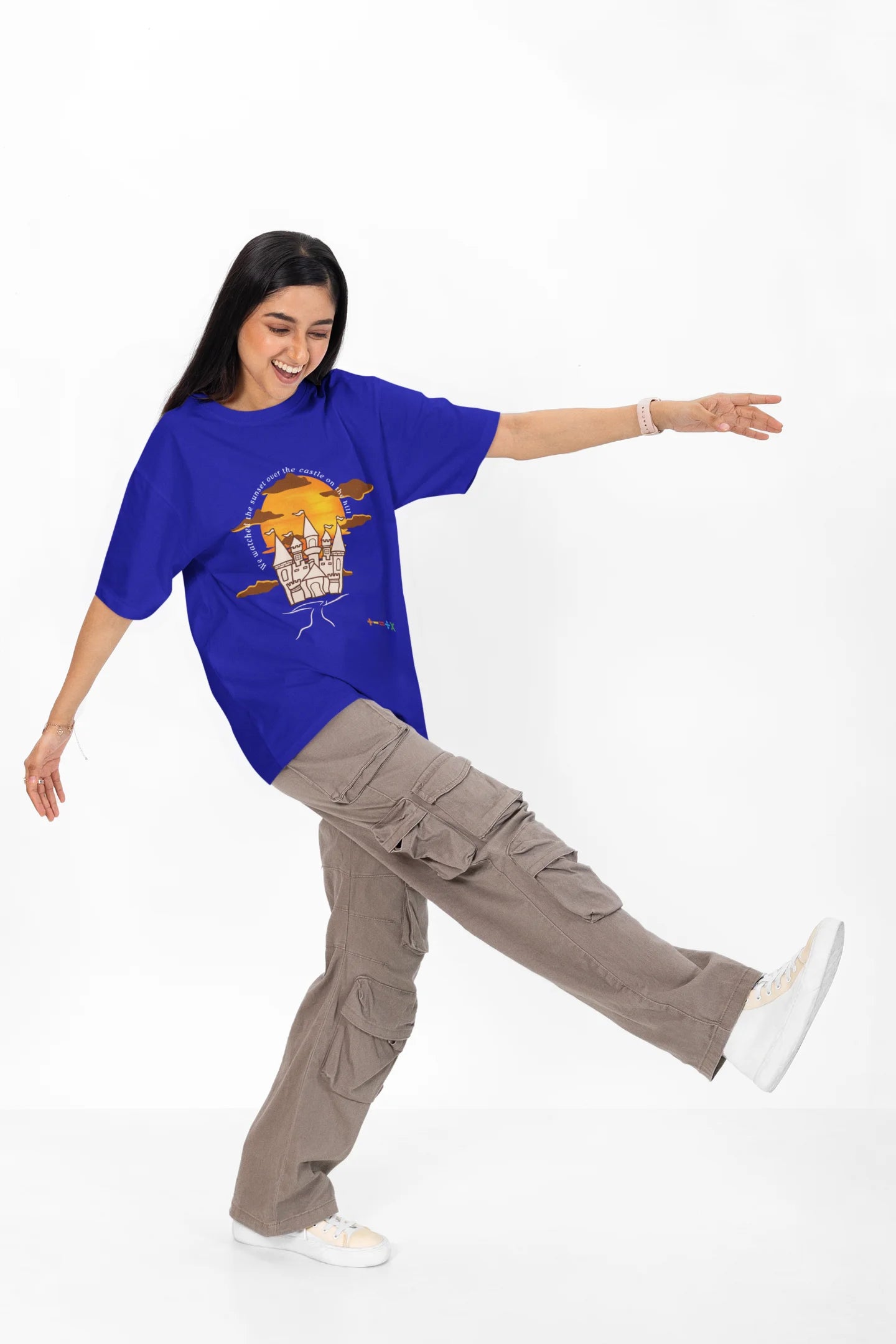 4th front view of a female model wearing a royal blue oversized t-shirt featuring a nostalgic sunset and castle design, related to Ed Sheeran's "Castle on the Hill."