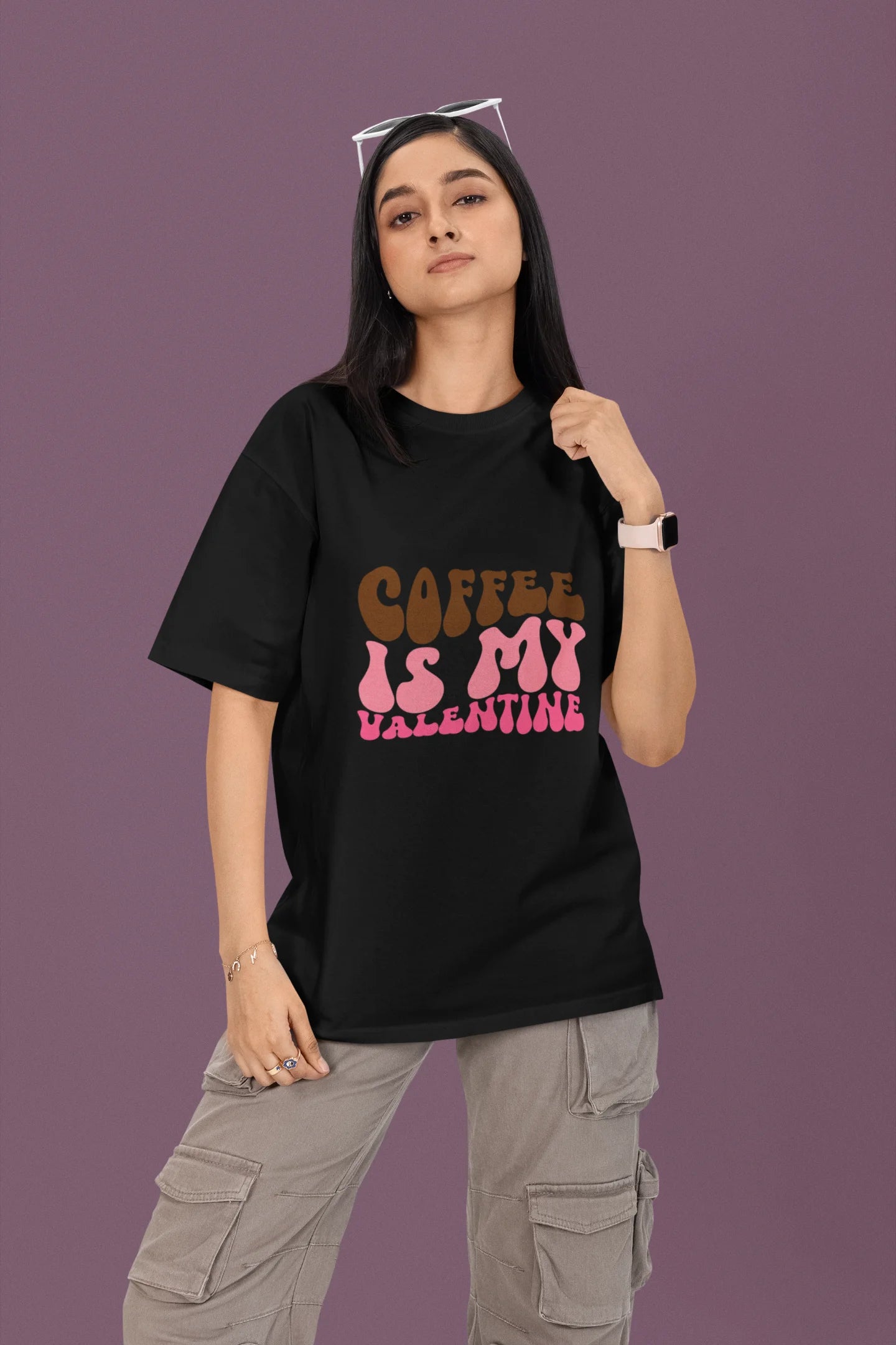 2nd front view of a female model wearing a black oversized t-shirt with the text "Coffee is My Valentine" printed on it.