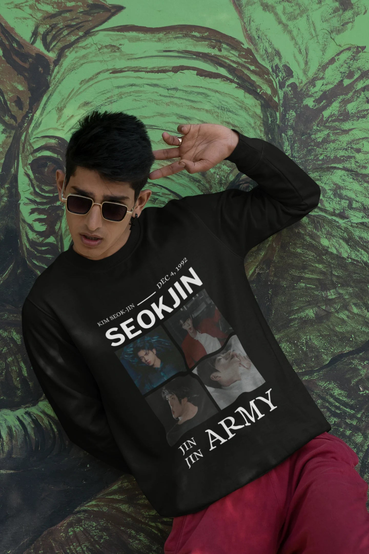 Third front view of male model wearing an black sweatshirt featuring a bold design inspired by BTS member Jin. Ideal for BTS fans (ARMY) and K-Pop enthusiasts looking for unique Korean Wave fashion.