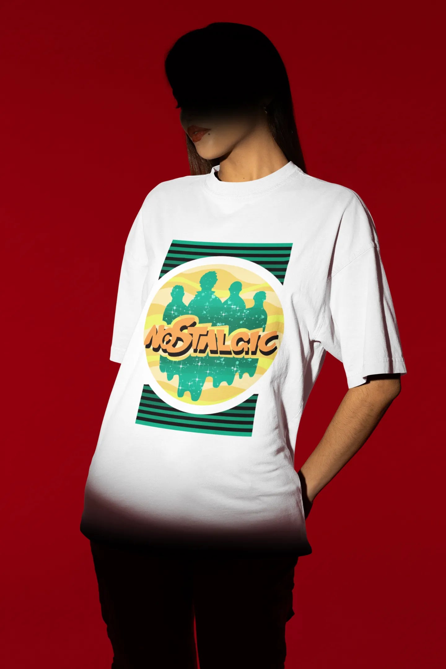 Third view of a female model wearing an oversized off-white t-shirt with a shadow silhouette of the Coldplay band members and the word "Nostalgic" printed on it.