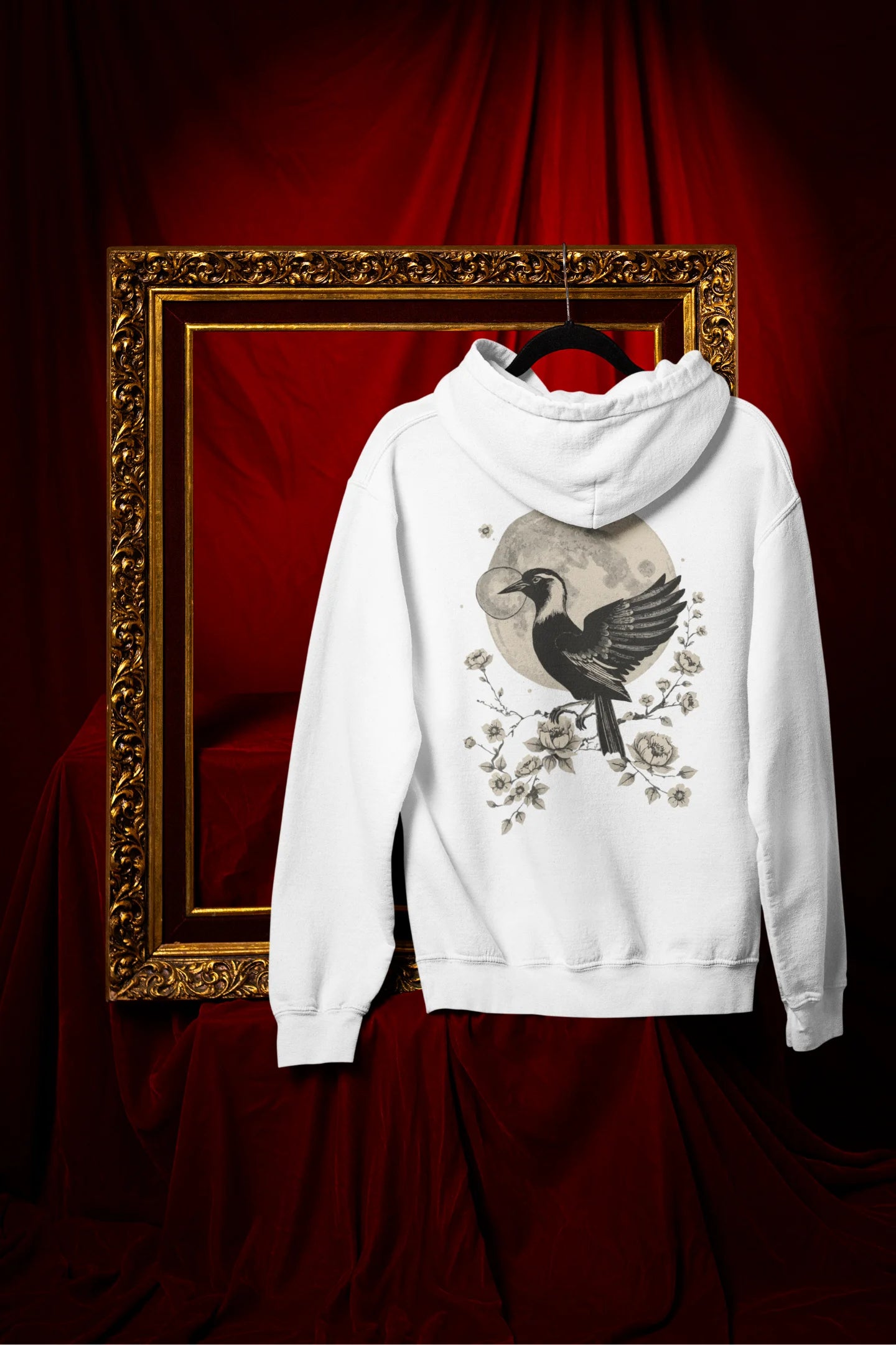 Back view of a white hoodie with a heron taking off under the moonlight.