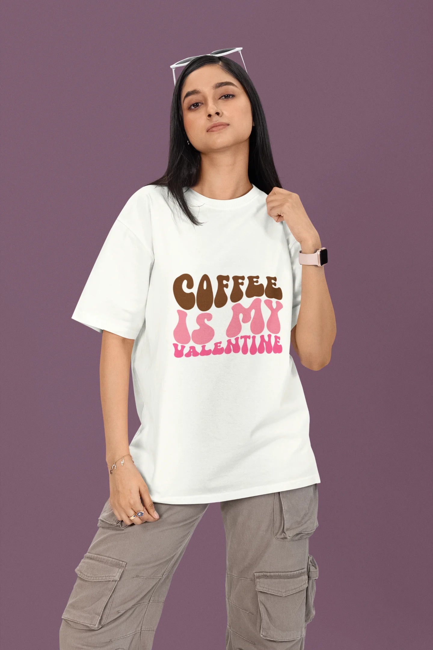 2nd front view of a female model wearing a white oversized t-shirt with the text "Coffee is My Valentine" printed on it.