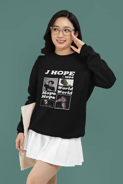 Second front view of a female model wearing a black sweatshirt featuring a vibrant design inspired by BTS member J-Hope (Hoseok). Ideal for BTS fans (ARMY) and K-Pop enthusiasts who love dance and rap-focused music.