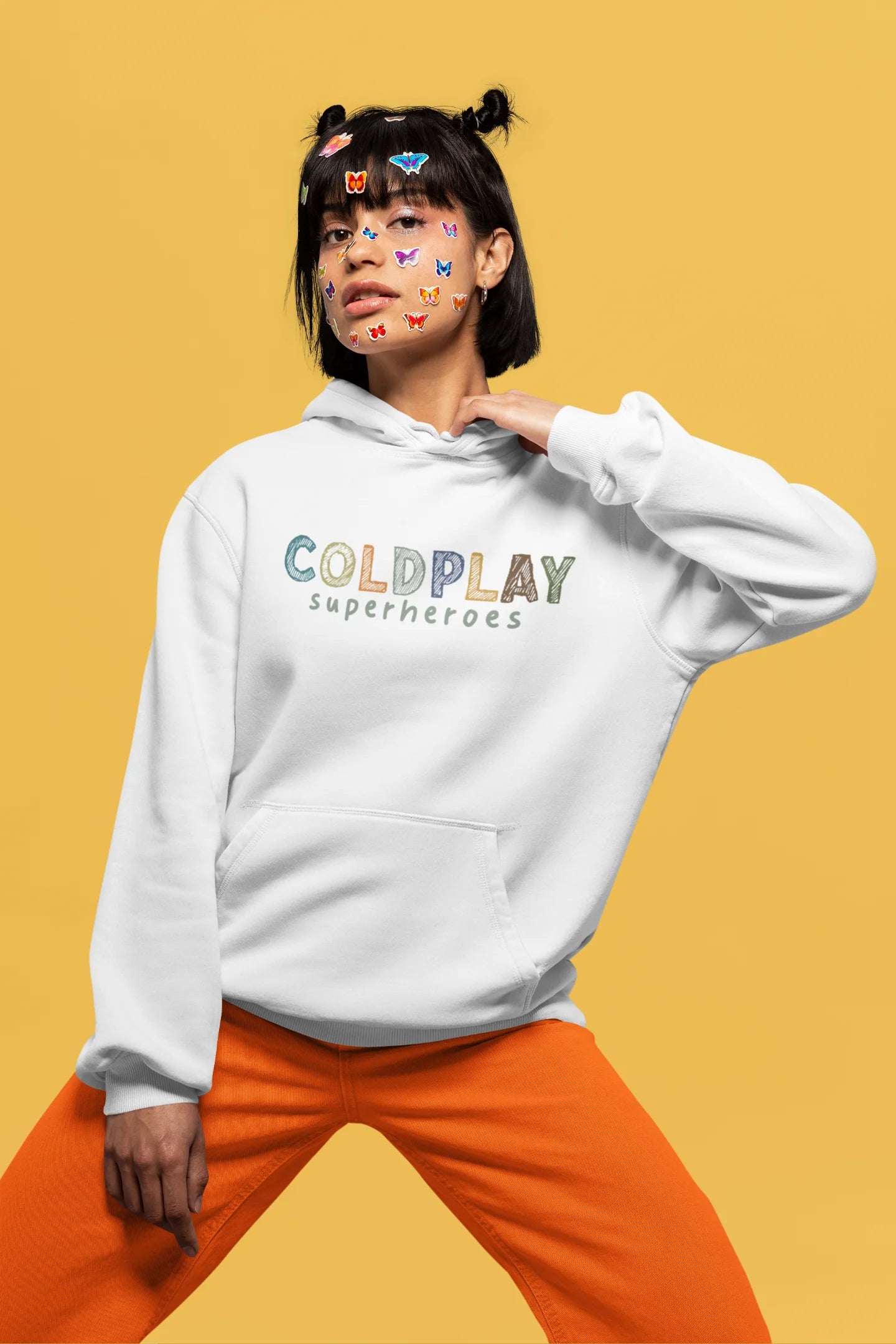 3rd front view of a female model wearing an off-white hoodie with a design inspired by the "Something Just Like This" music video, featuring the word "Superheroes".