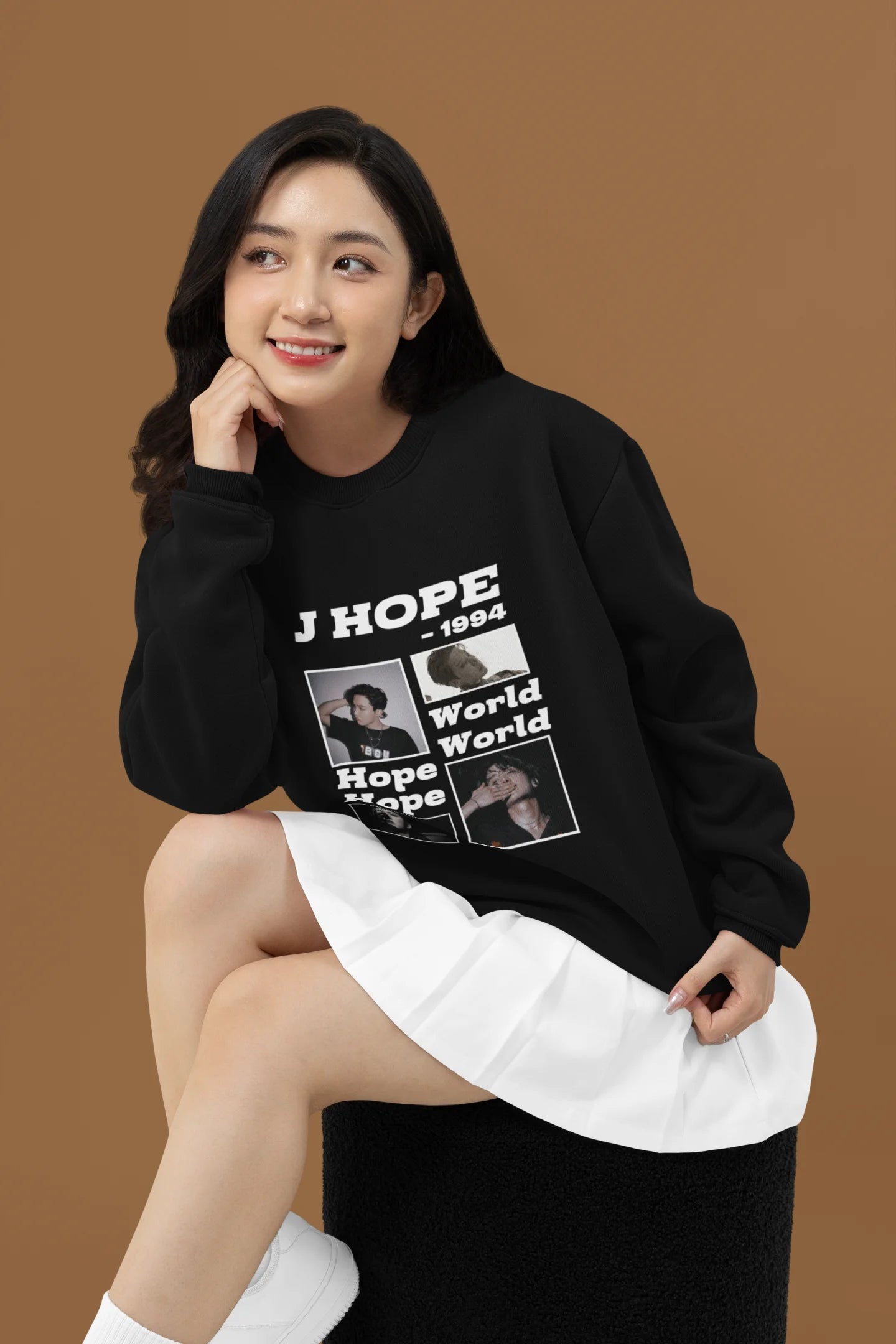 First front view of a female model wearing a black sweatshirt featuring a vibrant design inspired by BTS member J-Hope (Hoseok). Ideal for BTS fans (ARMY) and K-Pop enthusiasts who love dance and rap-focused music.