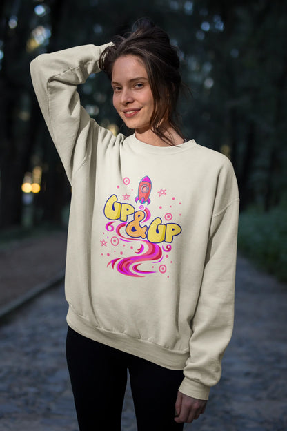 Third front view of a male model wearing an cream sweatshirt with a rocket ship design and the text "Up & Up".