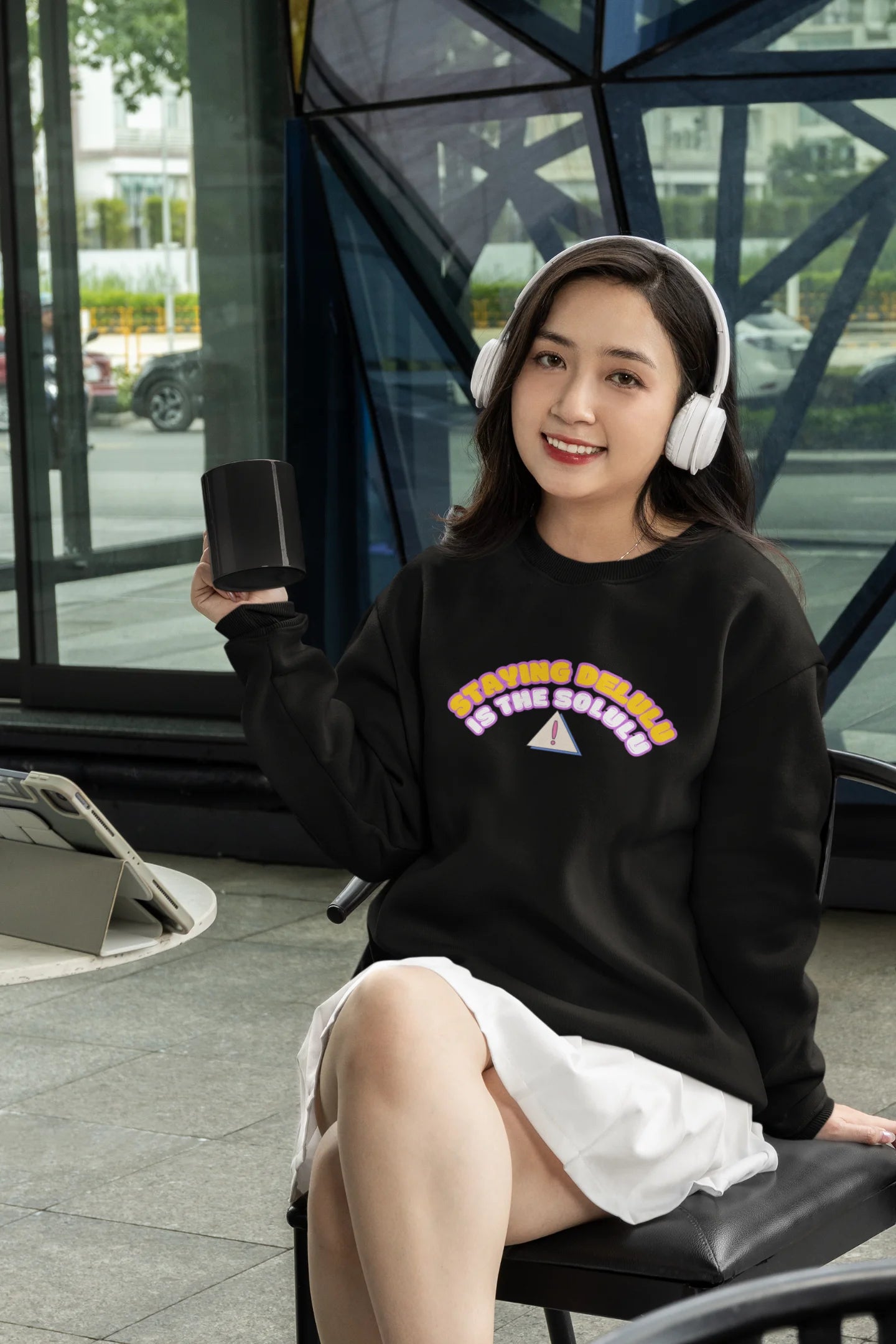 First front view of female model wearing a black sweatshirt with the hilarious message "Stay Delulu" in a bold design. Ideal for those who love trendy slang and lighthearted humor.