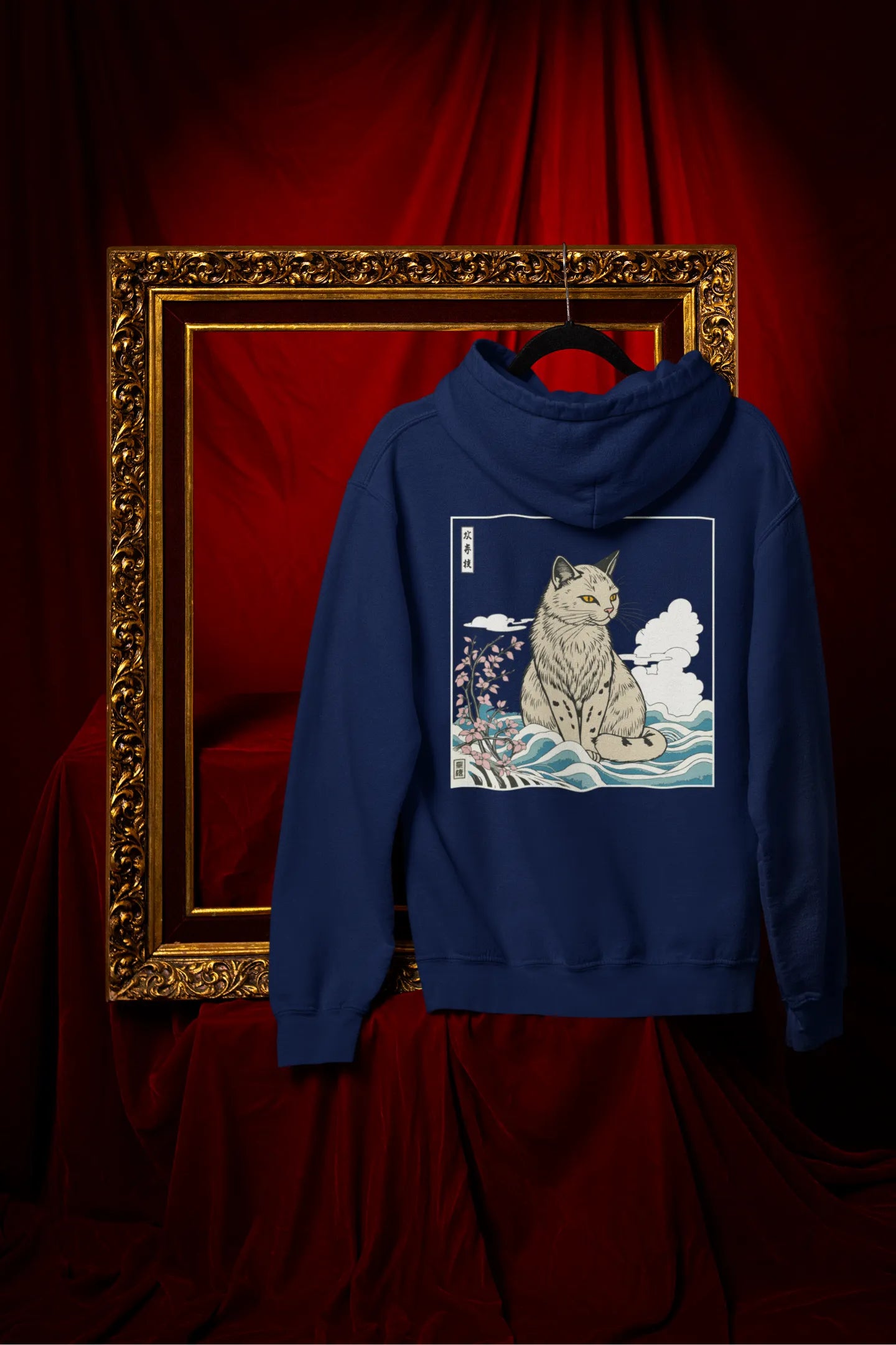 Back view of a navy blue hoodie with a design of a wildcat sitting on ocean waves.