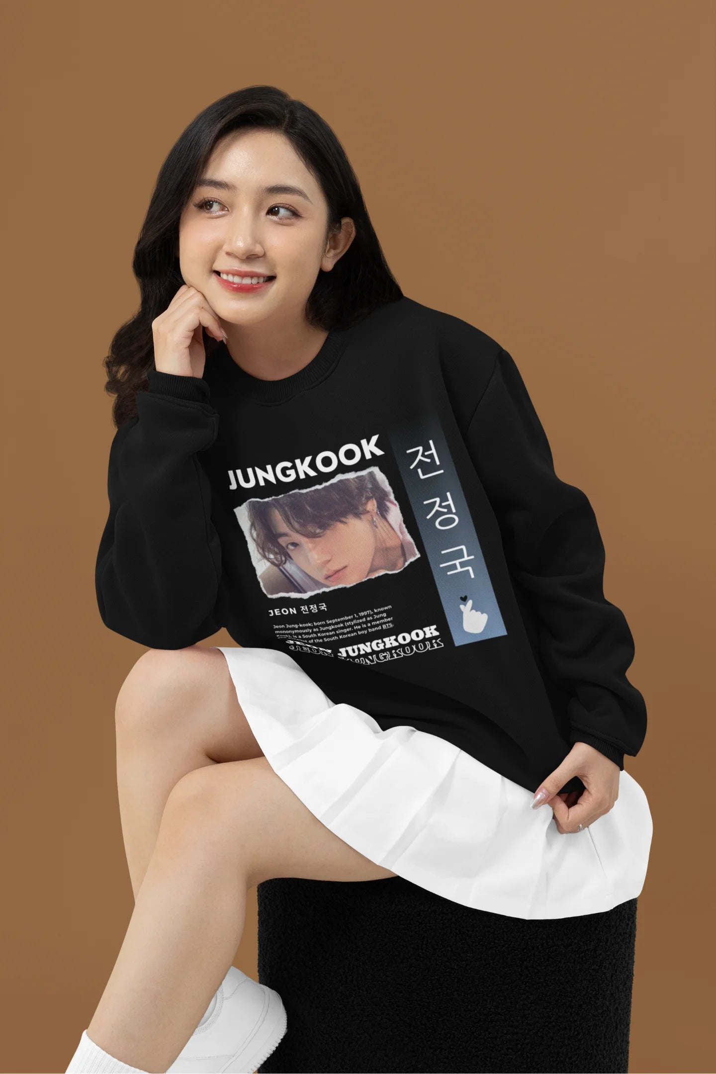Second front view of a female model wearing a black sweatshirt featuring a vibrant design inspired by BTS member Jungkook. Ideal for fans of BTS and K-Pop music in general.