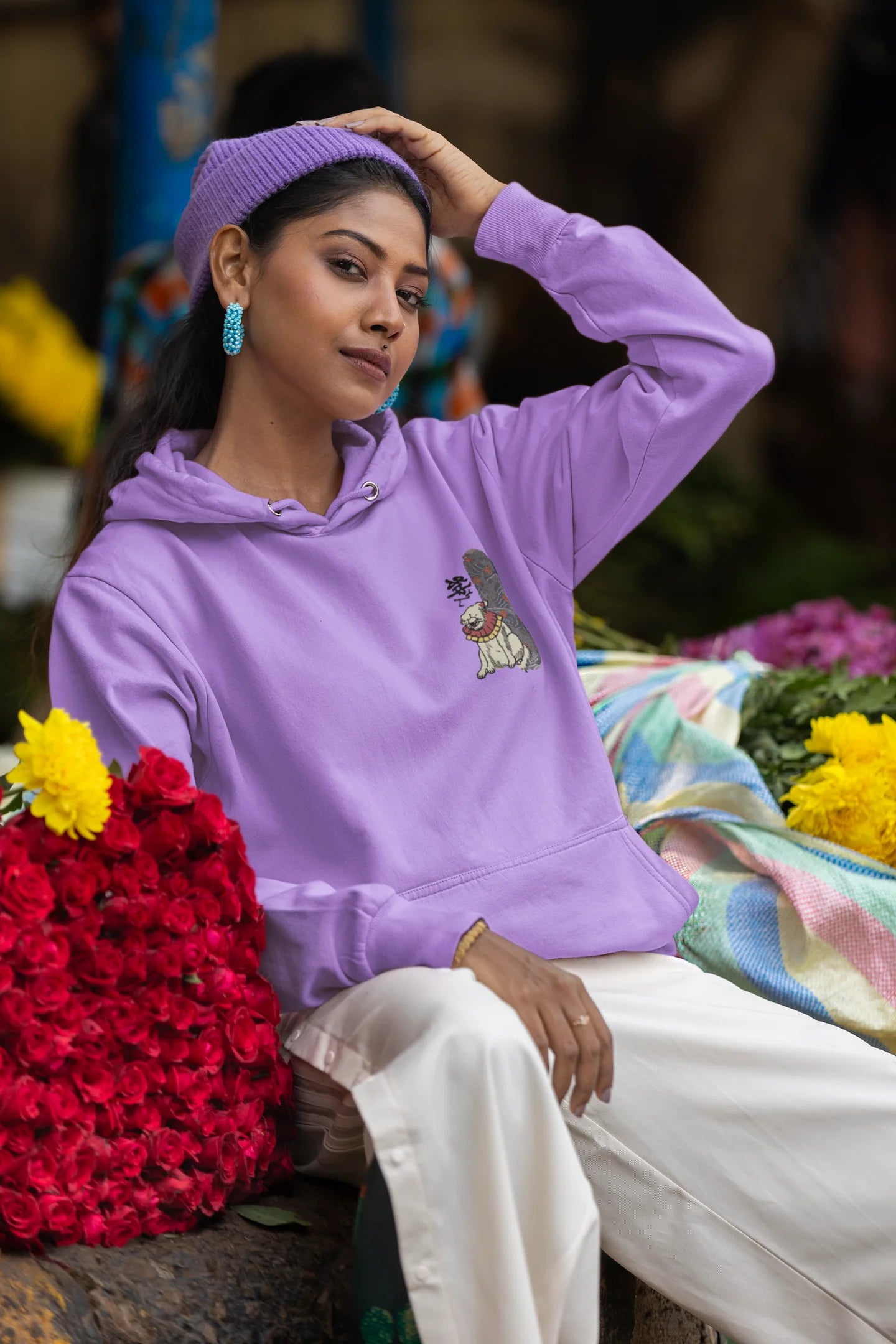 Fifth front view of a female model wearing a lavender hoodie with a design of a mythical Japanese dog.