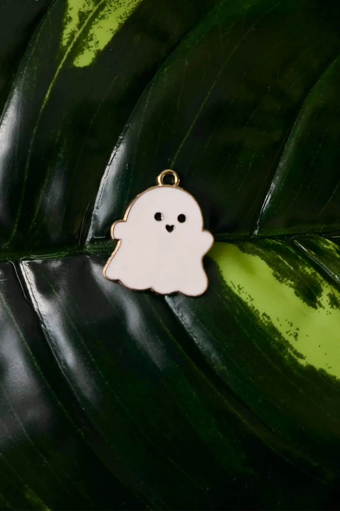 First view of a charm featuring a cute 
white spooky adorable ghost design.