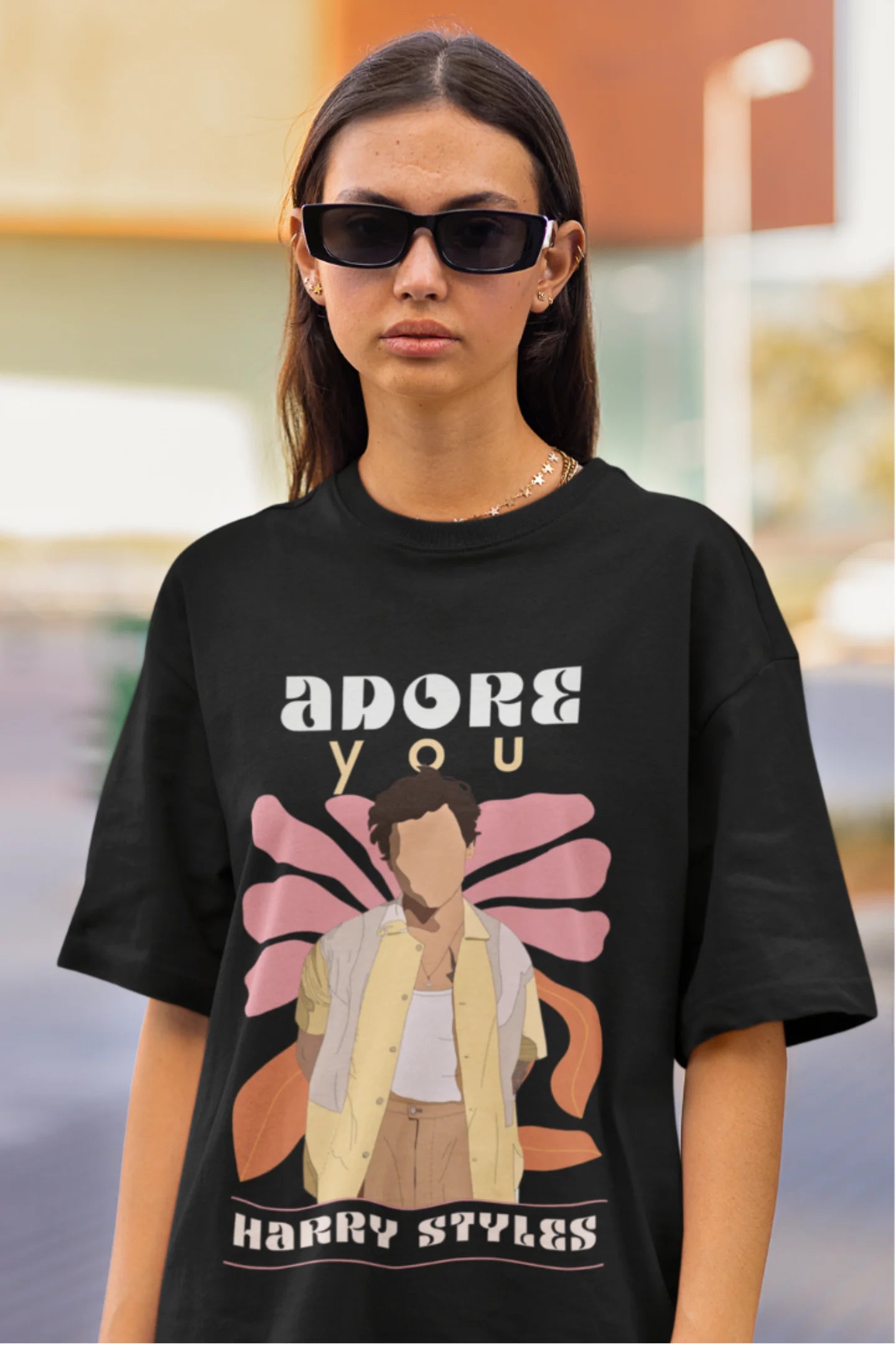 Third image of woman wearing black oversized t-shirt featuring 'Adore You' inspired design - ideal for fans of Harry Styles and One Direction