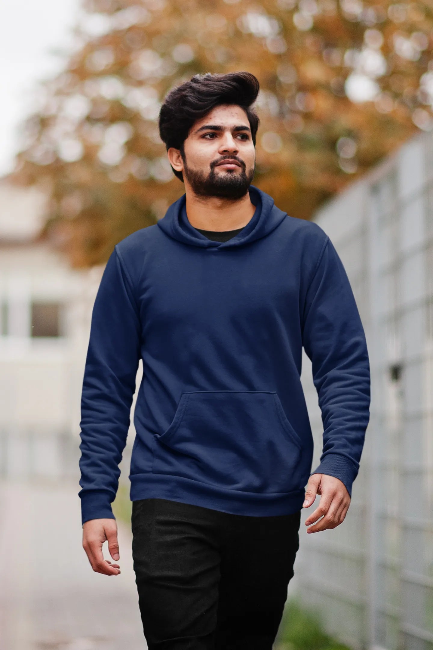 Second front view of a male model wearing a navy blue hoodie featuring a Range Rover Defender design, exuding power and ruggedness.