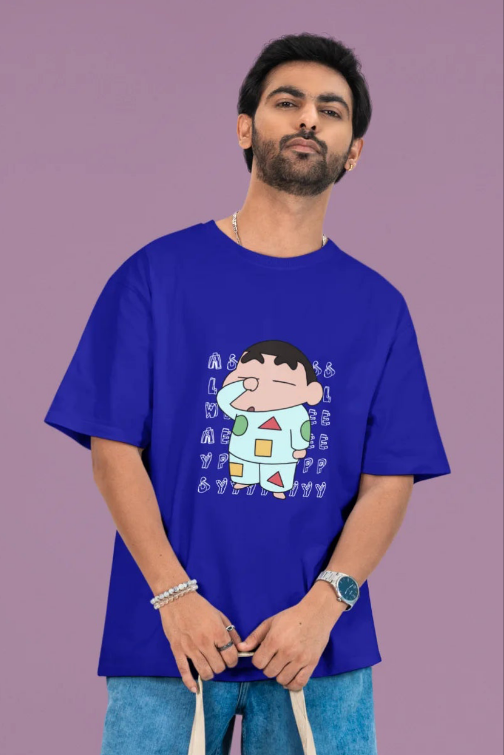 2nd front view of a male model wearing a royal blue oversized t-shirt featuring  Shinchan looking sleepy.