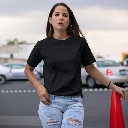 Front view of a female model wearing a black oversized, premium quality, pure cotton t-shirt.