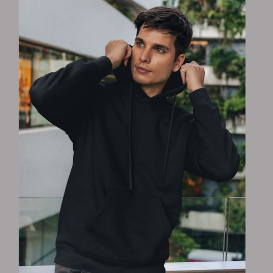 Front view of a male model wearing a black premium quality, pure cotton hoodie.