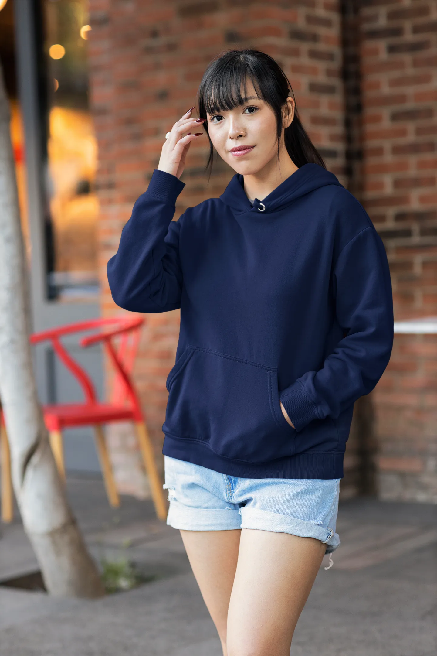 Front view of a female model wearing a navy blue premium quality, pure cotton hoodie.