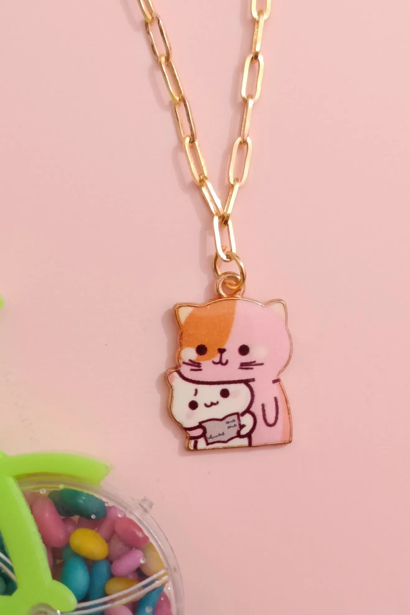 Fifth view of an anti tarnish gold chain necklace featuring a design of a mother cat and her kitten.