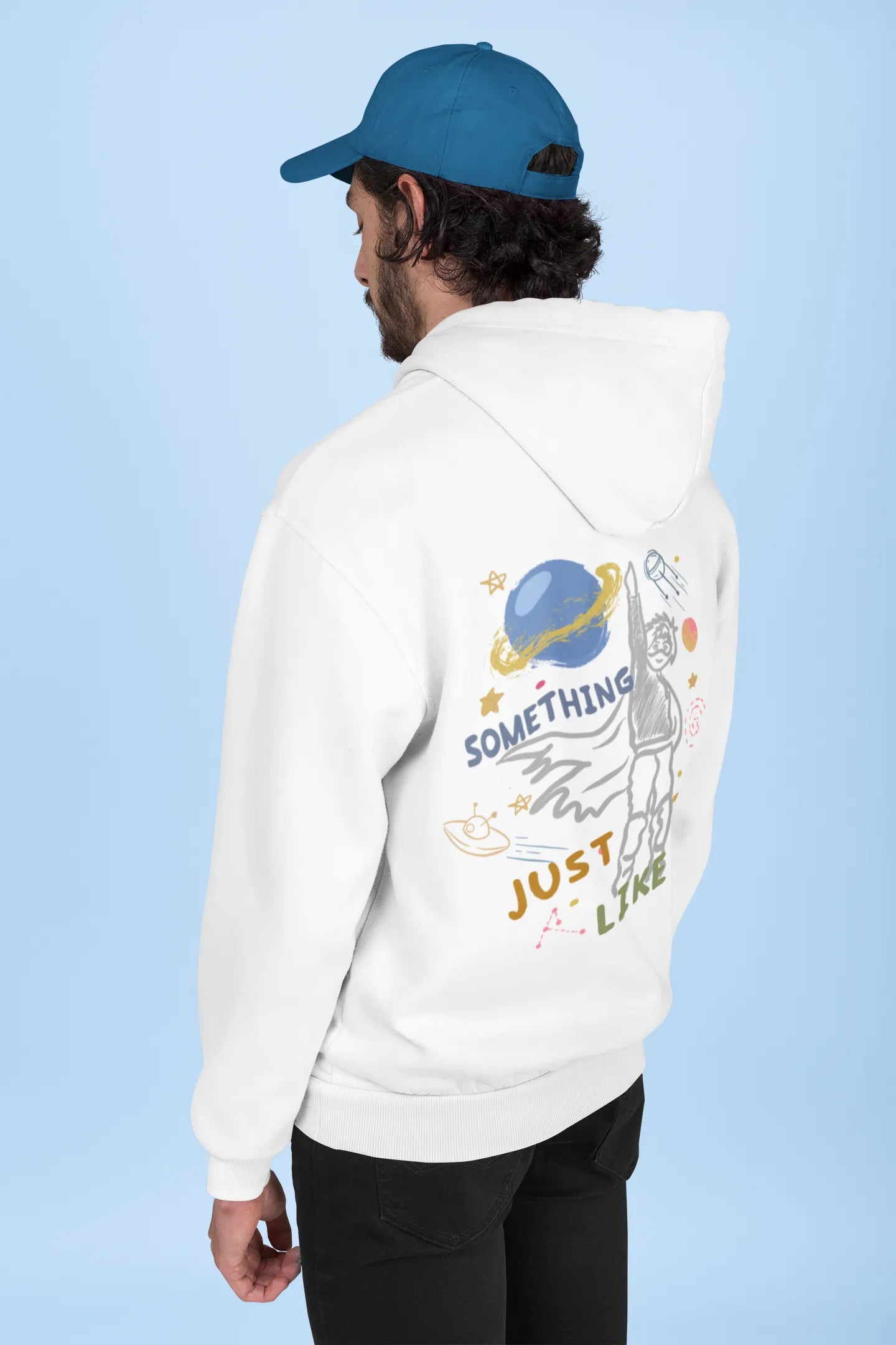 Back view of a male model wearing an off-white hoodie with a design inspired by the "Something Just Like This" music video, featuring the word "Superheroes".