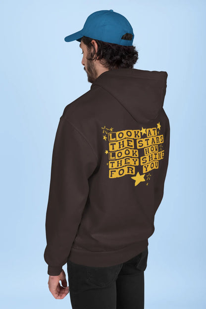 Back view of a male model wearing a chocolate brown hoodie with the "Yellow" album artwork by Coldplay.