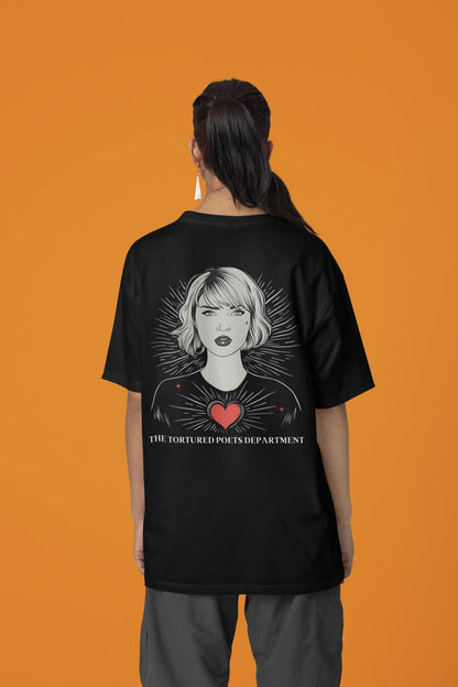 Back view of woman wearing black Oversize Taylor Swift T-Shirt featuring Fortnight Theme.