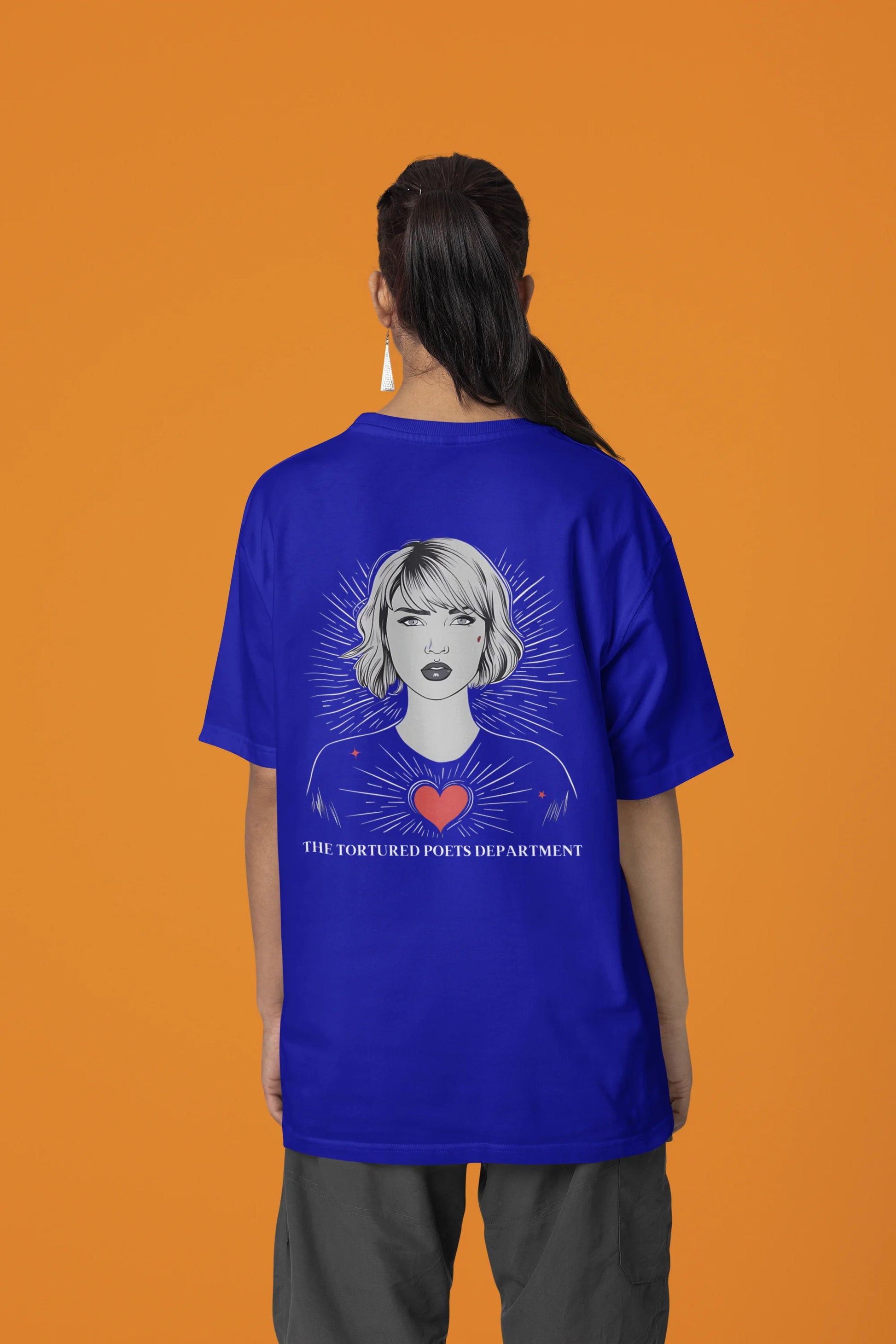 Back view of woman wearing blue Oversize Taylor Swift T-Shirt featuring Fortnight Theme.
