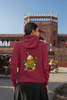 Back view of a female model wearing a maroon hoodie with a Disney Uncle Scrooge design, showing dollar bills raining down on him.