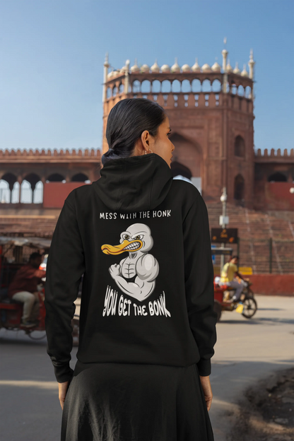 Back view of a female model wearing a black hoodie with a Disney design featuring a muscular duck and the text "The Honk."