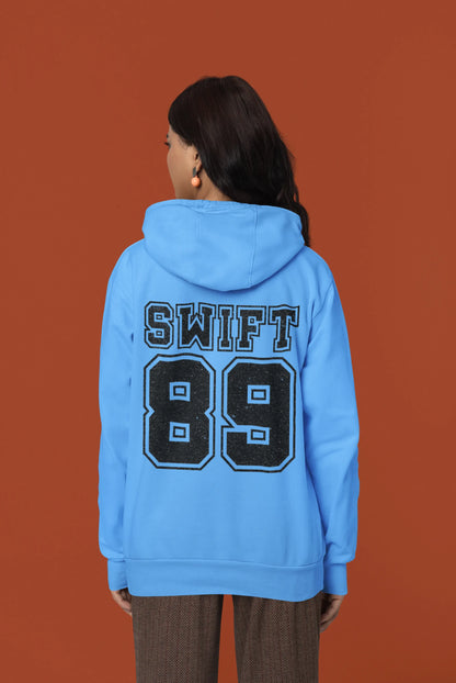 Back view of a female Model wearing a sky blue Swift 89 hoodie, inspired by Taylor Swift's 1989 album. Perfect for Swifties and Eras Tour fans.