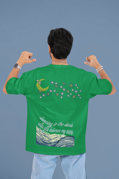 Back view of a male model wearing a forest green oversized t-shirt featuring lyrics from Ed Sheeran's song "Perfect" against a night sky design.