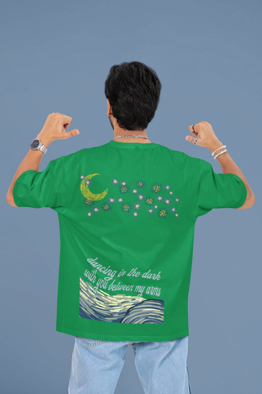 Back view of a male model wearing a forest green oversized t-shirt featuring lyrics from Ed Sheeran's song "Perfect" against a night sky design.