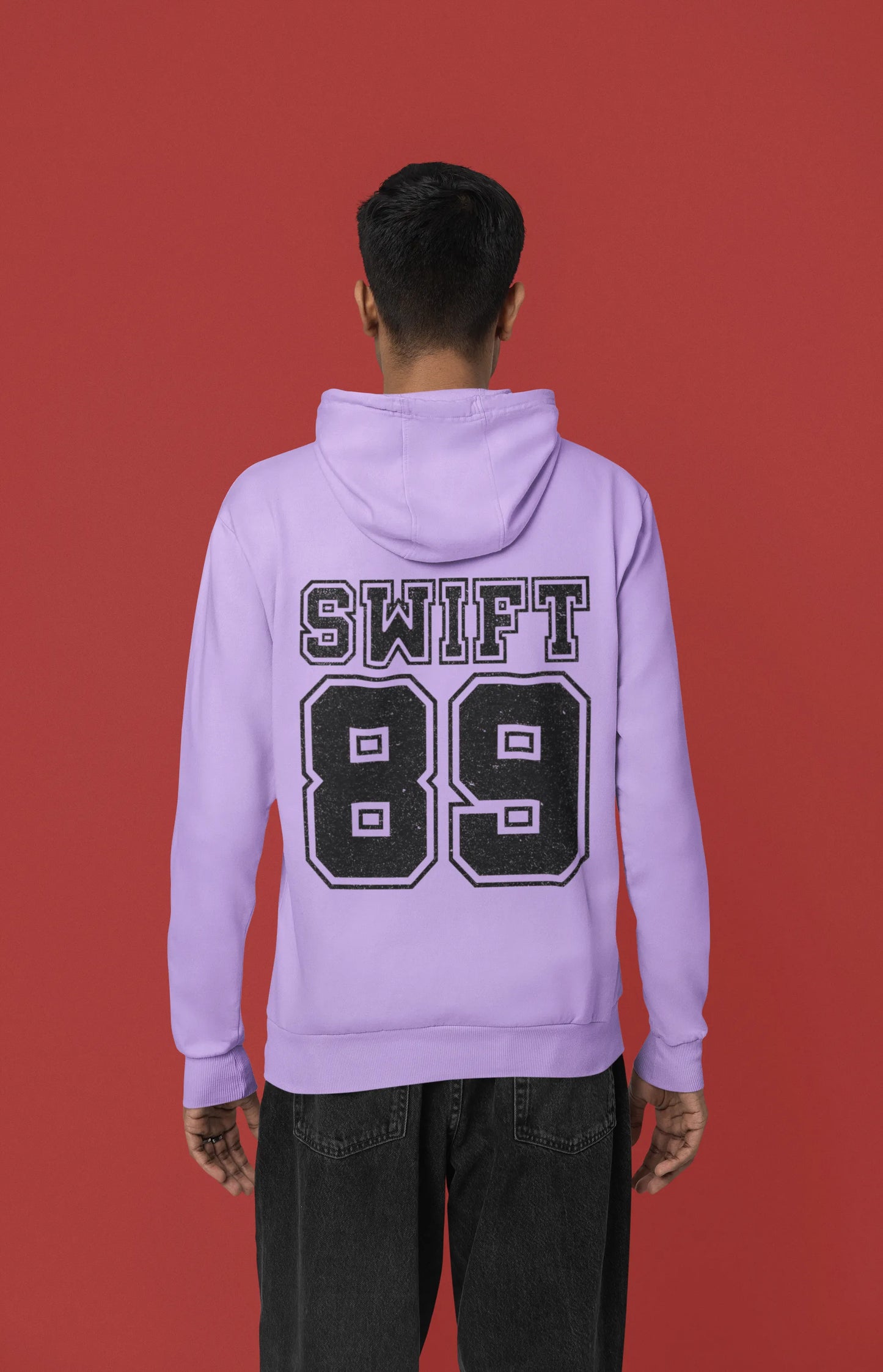 Back view of a male Model wearing a lavender Swift 89 hoodie, inspired by Taylor Swift's 1989 album. Perfect for Swifties and Eras Tour fans.