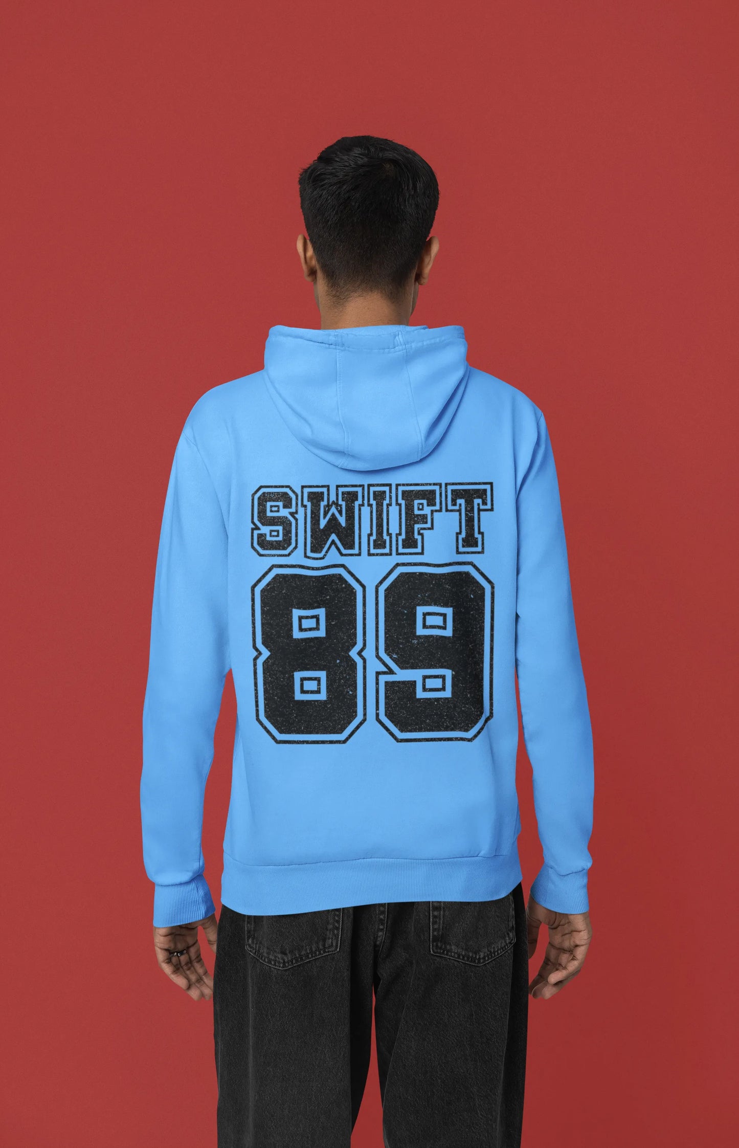 Back view of a male Model wearing a sky blue Swift 89 hoodie, inspired by Taylor Swift's 1989 album. Perfect for Swifties and Eras Tour fans.