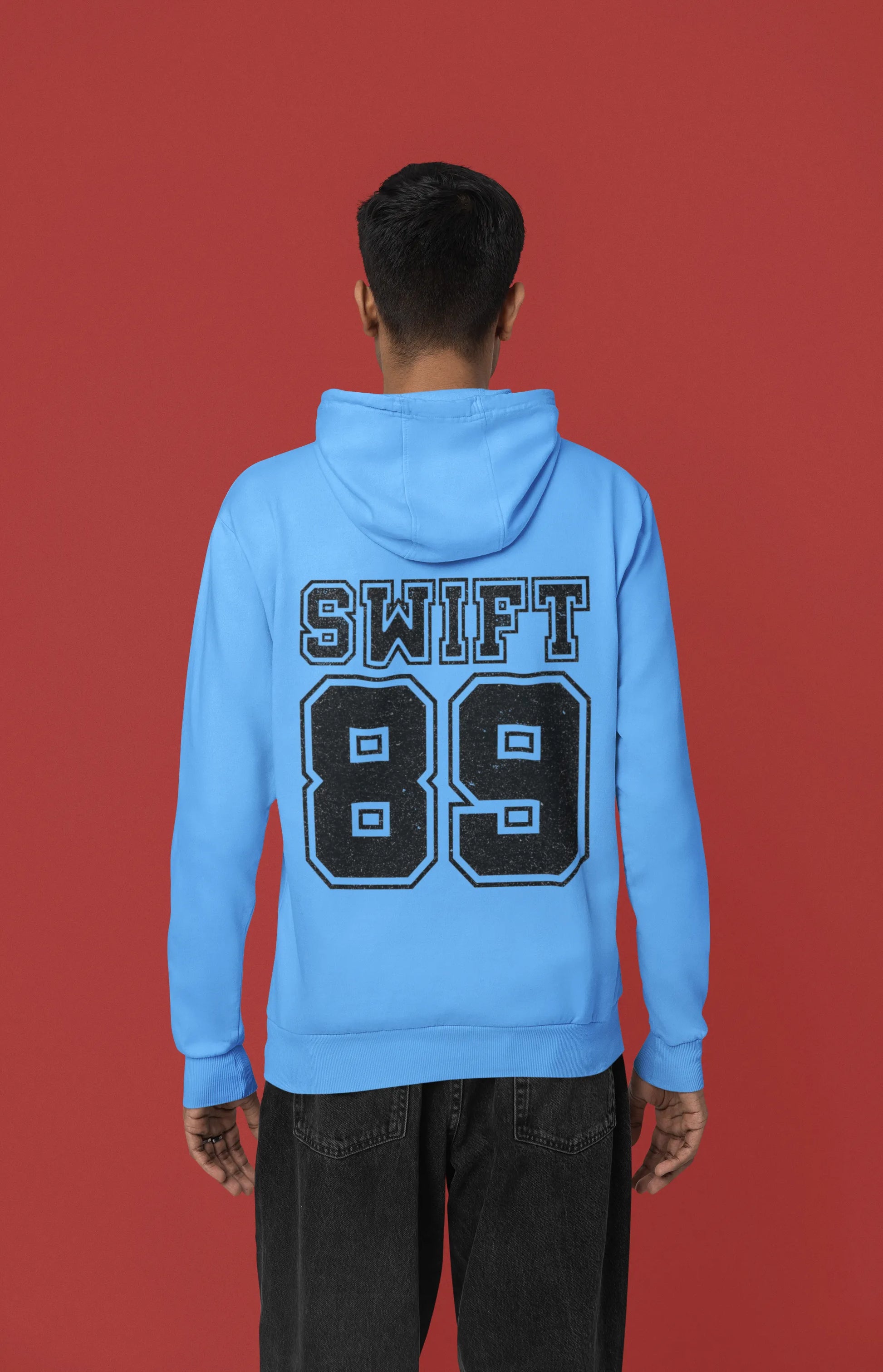 Back view of a male Model wearing a sky blue Swift 89 hoodie, inspired by Taylor Swift's 1989 album. Perfect for Swifties and Eras Tour fans.