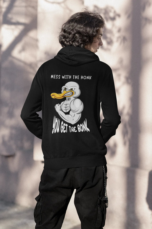 Back view of a male model wearing a black hoodie with a Disney design featuring a muscular duck and the text "The Honk."