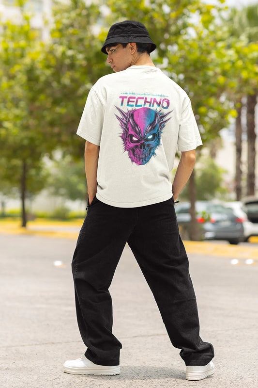Back view of a male model wearing an off-white oversized t-shirt with a stylized Techno Skull design, perfect for rave and party vibes.