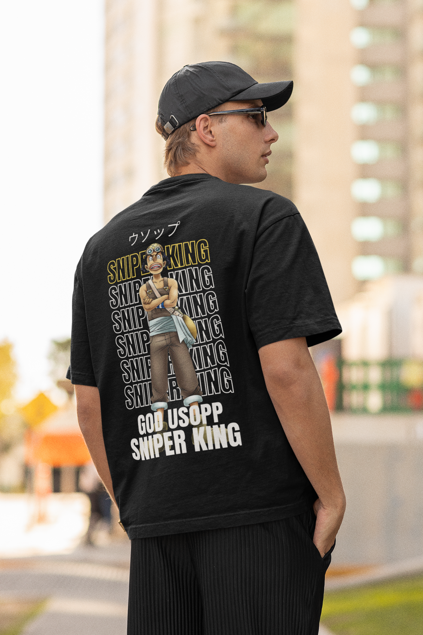 Back view of a male model wearing a black oversized t-shirt featuring Usopp from the One Piece anime.