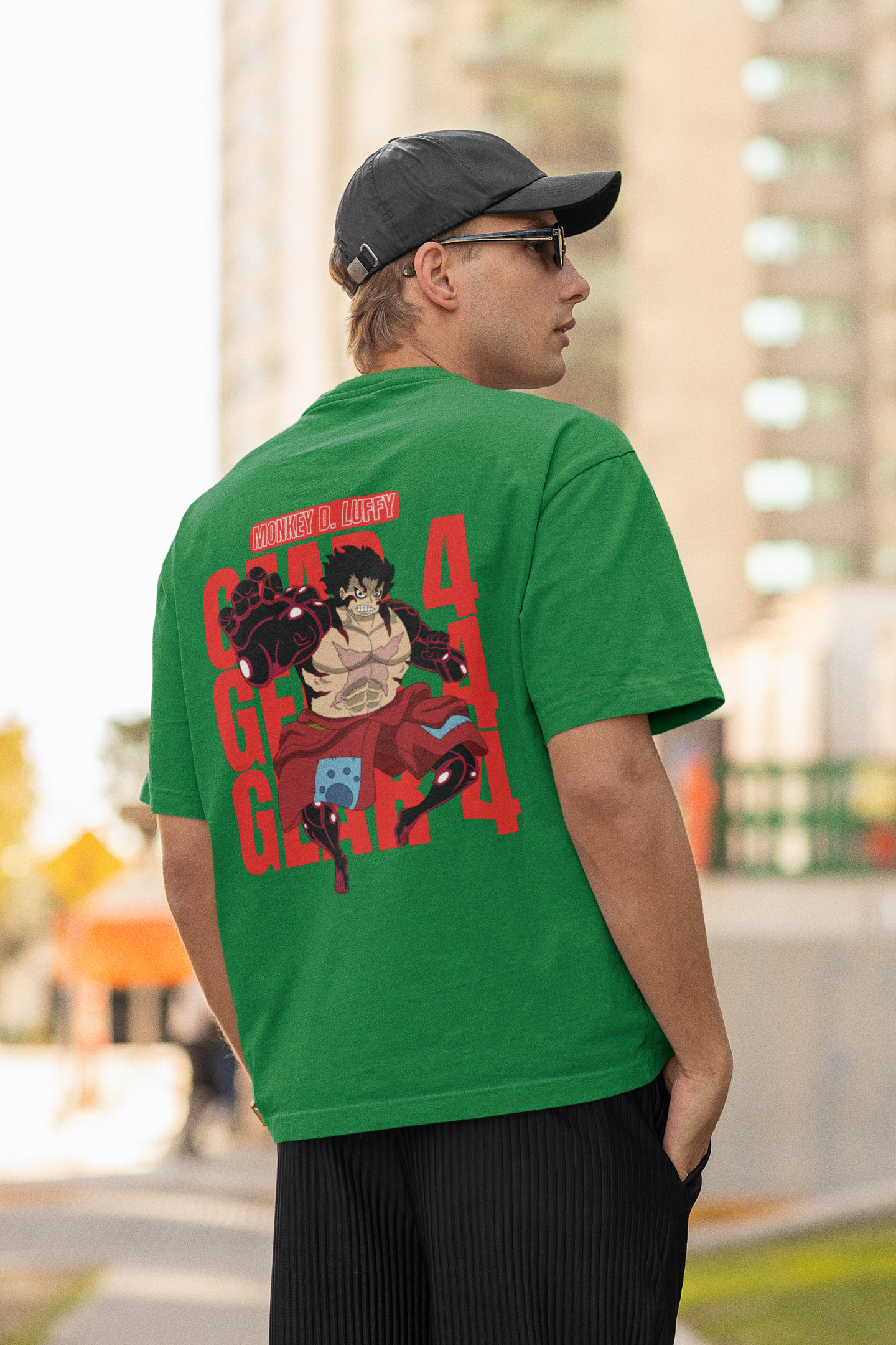 Back view of a male model wearing a forest green oversized t-shirt featuring Luffy in his Gear 4 Bounceman form from the One Piece anime.