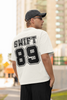 Back view of man wearing Off White coloured Oversize T-shirt featuring Taylor Swift 1989 design, Taylor's Version, and Eras Tour Merch