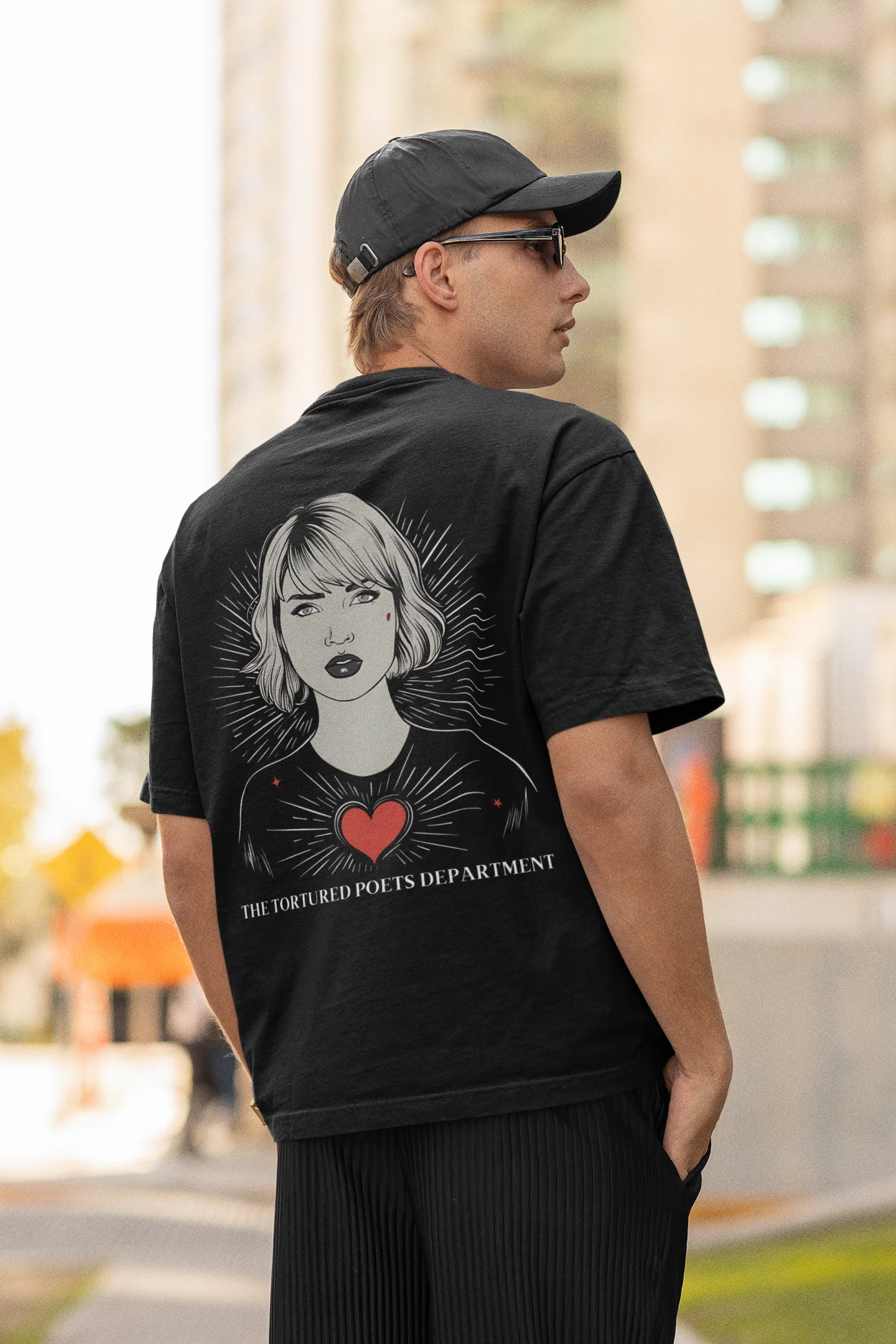 Back view of man wearing black Oversize Taylor Swift T-Shirt featuring Fortnight Theme